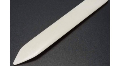 A tool made of bone for shaping the surface of leather